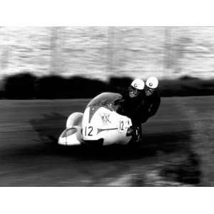 , Wearing Leather Jackets, Crash Helmets and Goggles, on a Racing 