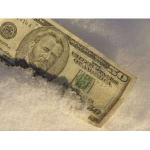  An American Fifty Dollar Bill on Fresh White Snow 