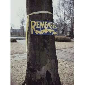  A Symbolic Yellow Ribbon and a Sign Saying Remember on a 