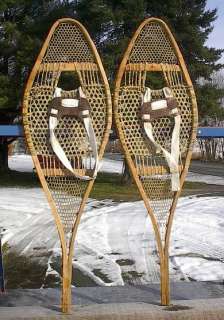 lot of snowshoes toboggans skis paddles and oars listed with a wide 