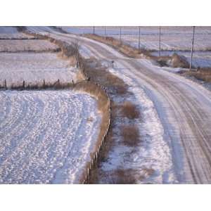  View of a Rural Country Road Covered in Snow Next to 