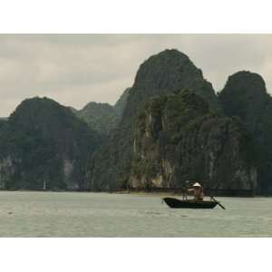  Woman in a Conical Hat Rows a Traditional Fishing Boat in 